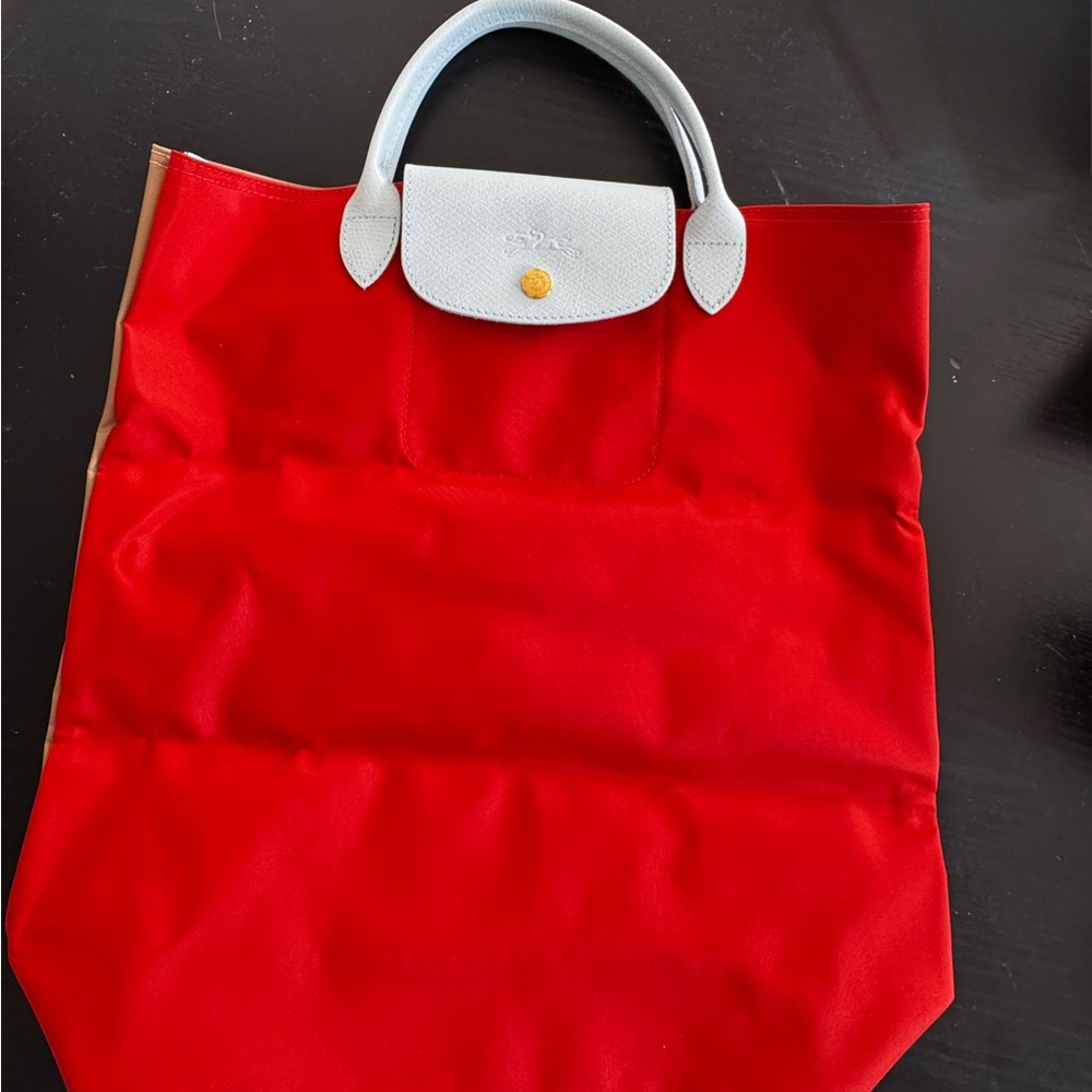 Longchamp Re/Play tote in Orange, beige and light blue.